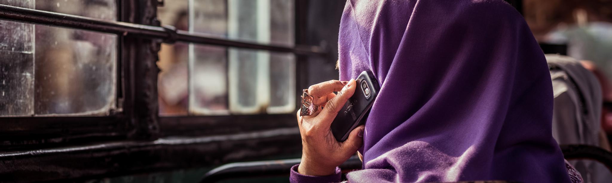 Indonesian lady on bus with mobile phone