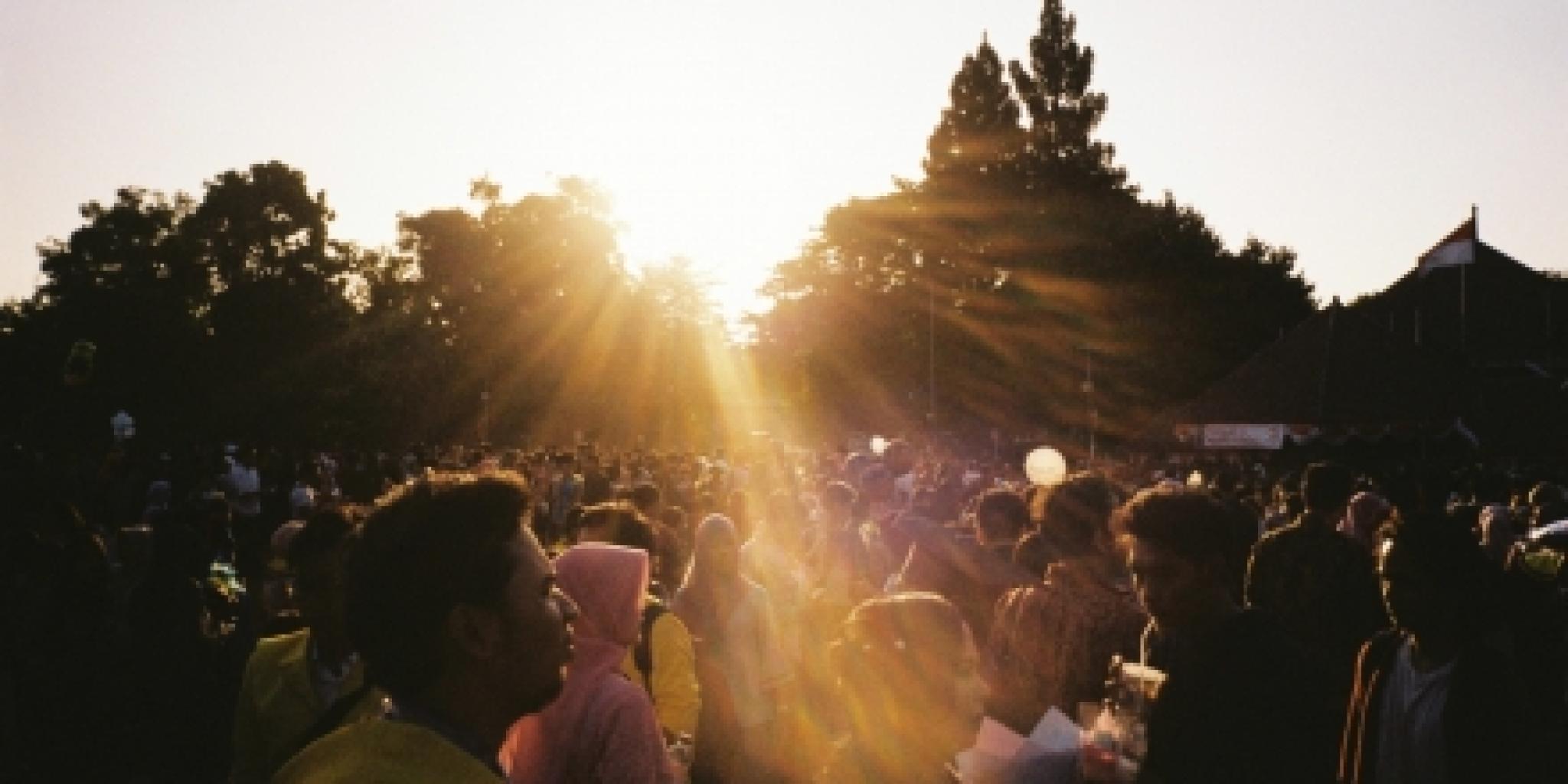 Sunlight streaming over a crowd